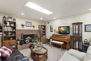 Carpeted living room featuring a fireplace