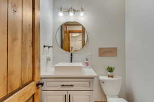 Bathroom with tasteful backsplash, vanity, and toilet