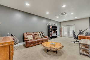 Home office featuring french doors and light colored carpet