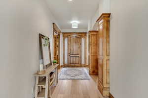 Doorway with light hardwood / wood-style flooring