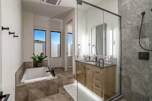 Full bathroom with toilet, independent shower and bath, and vanity