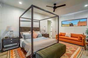 Bedroom with ceiling fan and hardwood / wood-style flooring