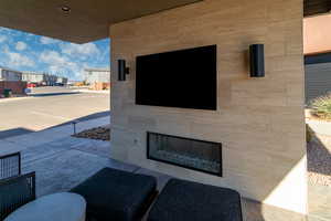 View of patio with a tiled fireplace