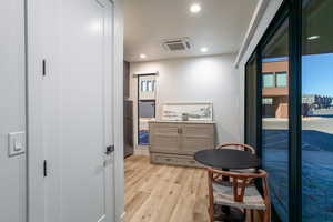 Corridor featuring light wood-type flooring