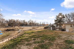 View of yard with a storage unit