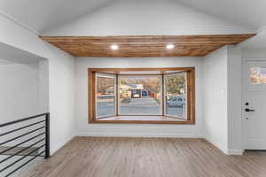 Interior space with light hardwood / wood-style flooring and lofted ceiling