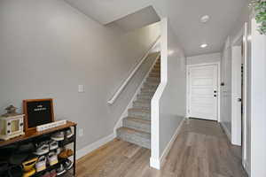 Stairway featuring hardwood / wood-style flooring