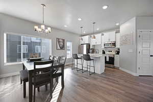 Dining area with a chandelier and light hardwood / wood-style flooring