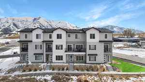 Snow covered building with a mountain view