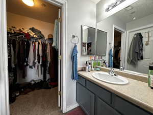 Bathroom with vanity and a textured ceiling