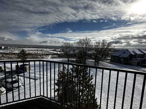 View of snow covered back of property