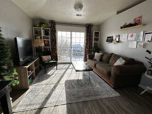 Living room featuring hardwood / wood-style floors and a textured ceiling