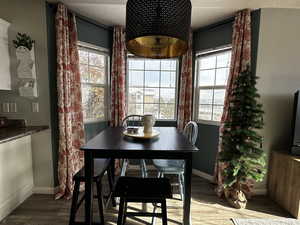 Dining room with hardwood / wood-style floors and a textured ceiling