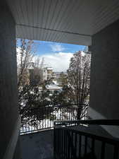 View of snow covered back of property