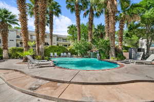 View of swimming pool with pool water feature and a patio area