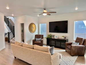 Living room featuring ceiling fan, a healthy amount of sunlight, and light wood-type flooring