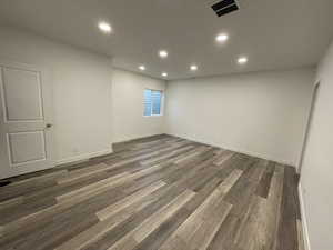 Unfurnished room with dark wood-type flooring