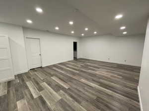 Basement with dark hardwood / wood-style flooring