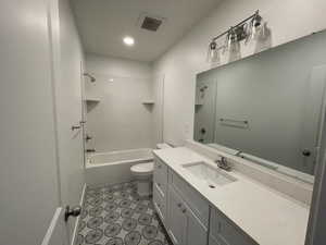 Full bathroom featuring tub / shower combination, vanity, and toilet