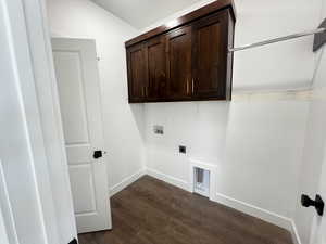 Washroom with cabinets, hookup for a washing machine, dark hardwood / wood-style floors, and hookup for an electric dryer