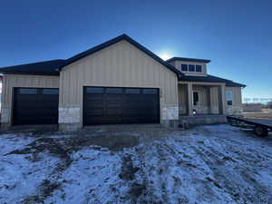 View of front of home with covered porch and a garage