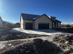 Modern farmhouse style home featuring a garage and a mountain view