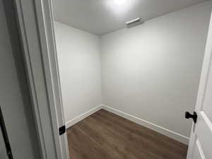 Spare room with dark wood-type flooring and a textured ceiling