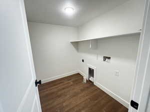 Laundry area featuring hookup for an electric dryer, dark hardwood / wood-style floors, washer hookup, and a textured ceiling