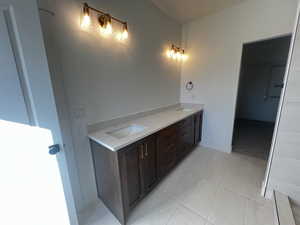 Bathroom with tile patterned flooring and vanity