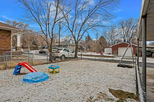 View of yard featuring a garage and an outbuilding