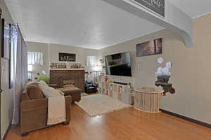 Living room featuring a fireplace and hardwood / wood-style flooring