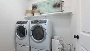 Clothes washing area featuring independent washer and dryer