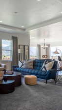 Carpeted living room featuring a textured ceiling