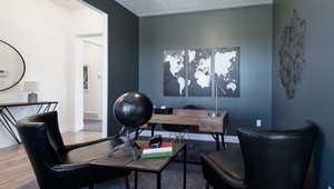 Office space featuring wood-type flooring and a textured ceiling