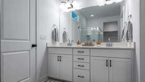 Bathroom featuring vanity and an enclosed shower