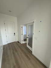 Hall with french door and light hardwood / wood-style floors