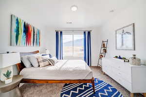 Bedroom featuring light colored carpet