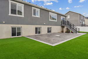 Back of house featuring a yard and a patio