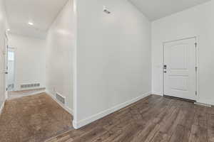 Foyer entrance with dark hardwood / wood-style flooring