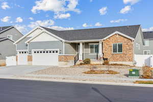 Ranch-style home featuring a porch and a garage