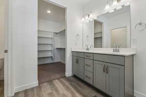 Bathroom with hardwood / wood-style floors and vanity