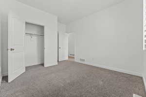 Unfurnished bedroom featuring carpet floors and a closet