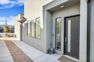 View of exterior entry featuring a patio area