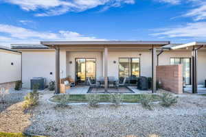 Rear view of property featuring central air condition unit and a patio area