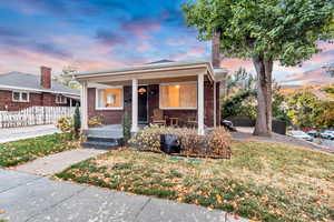 View of front of house with a yard and a porch