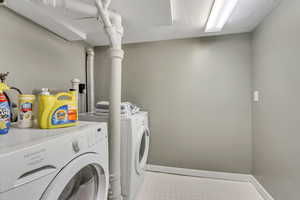 Laundry room featuring washer and dryer and a textured ceiling