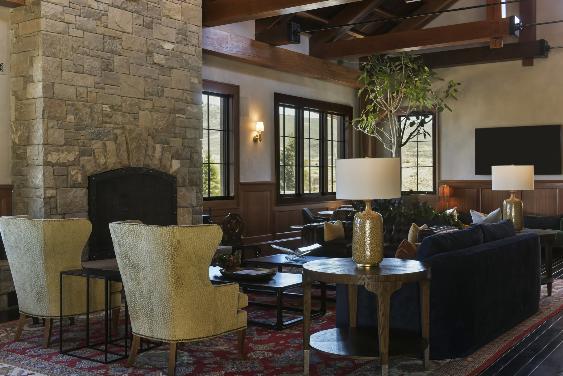 Living room with a fireplace and lofted ceiling with beams