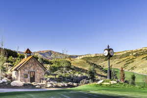 Exterior space featuring a mountain view and a lawn