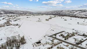 Snowy aerial view featuring a mountain view