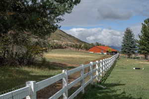 View of yard with a rural view and a mountain view